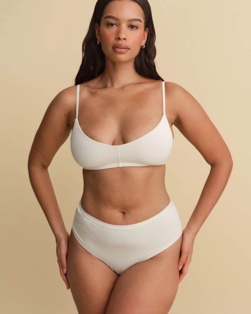 Model wearing white MATE the Label organic cotton underwear with a matching bralette.
