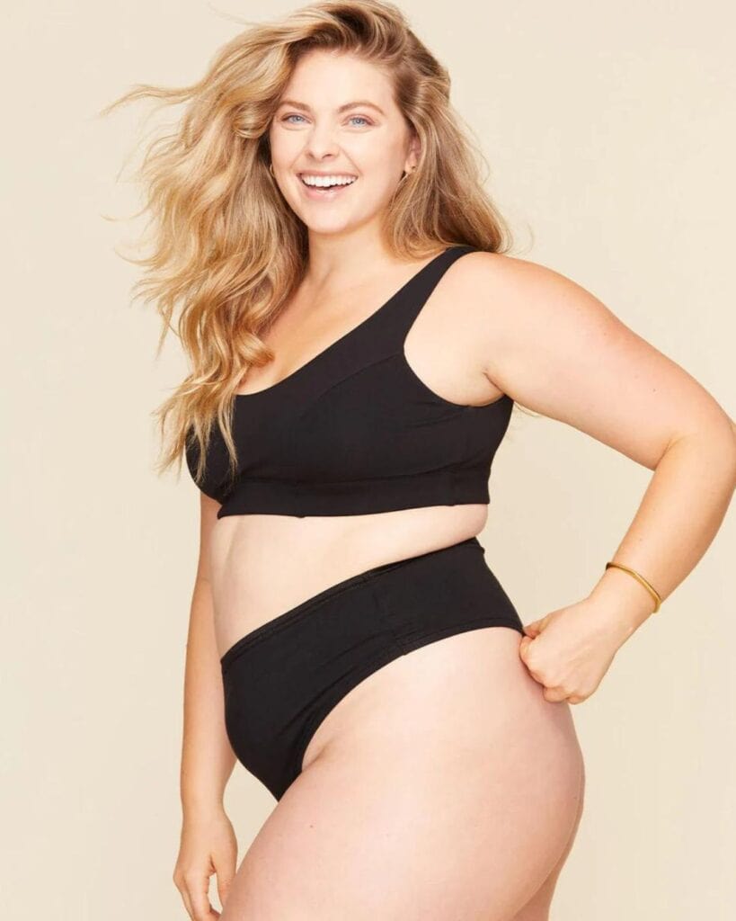 Model wearing black Subset organic cotton underwear with a matching black bralette.