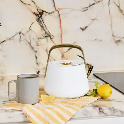 Caraway white non-toxic tea kettle made with ceramic-coated stainless steel, PFAS-free and lead-free stovetop kettle.