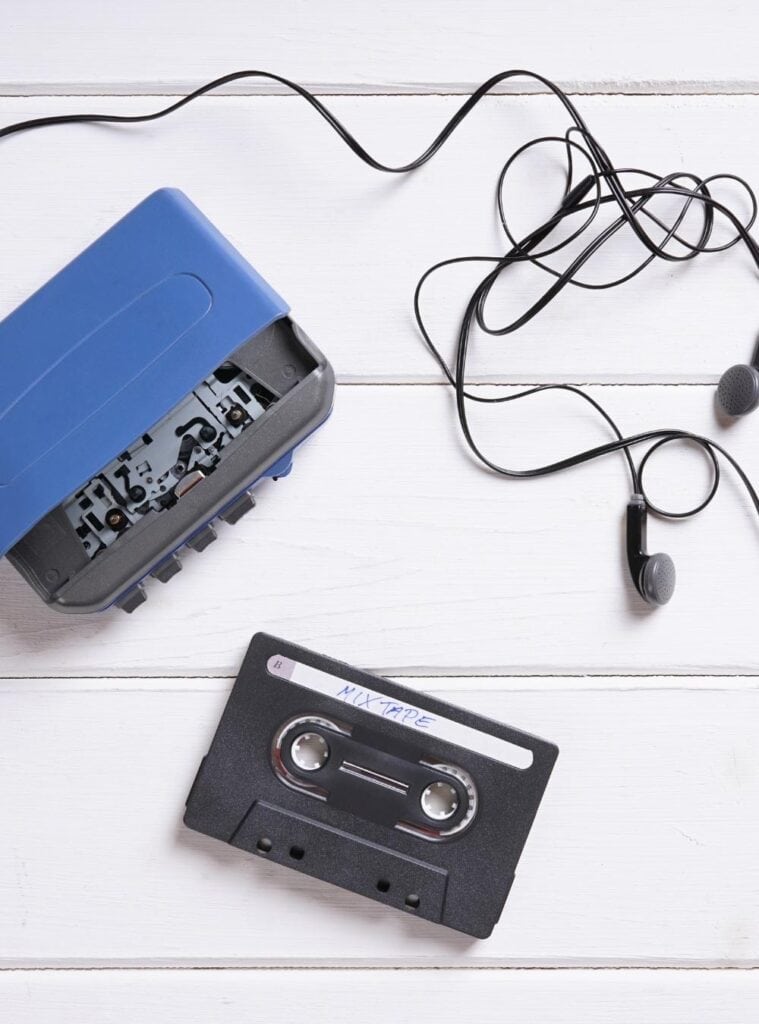 Smartphone displaying a personalized playlist with headphones, wrapped as a modern take on the classic mixed tape.
