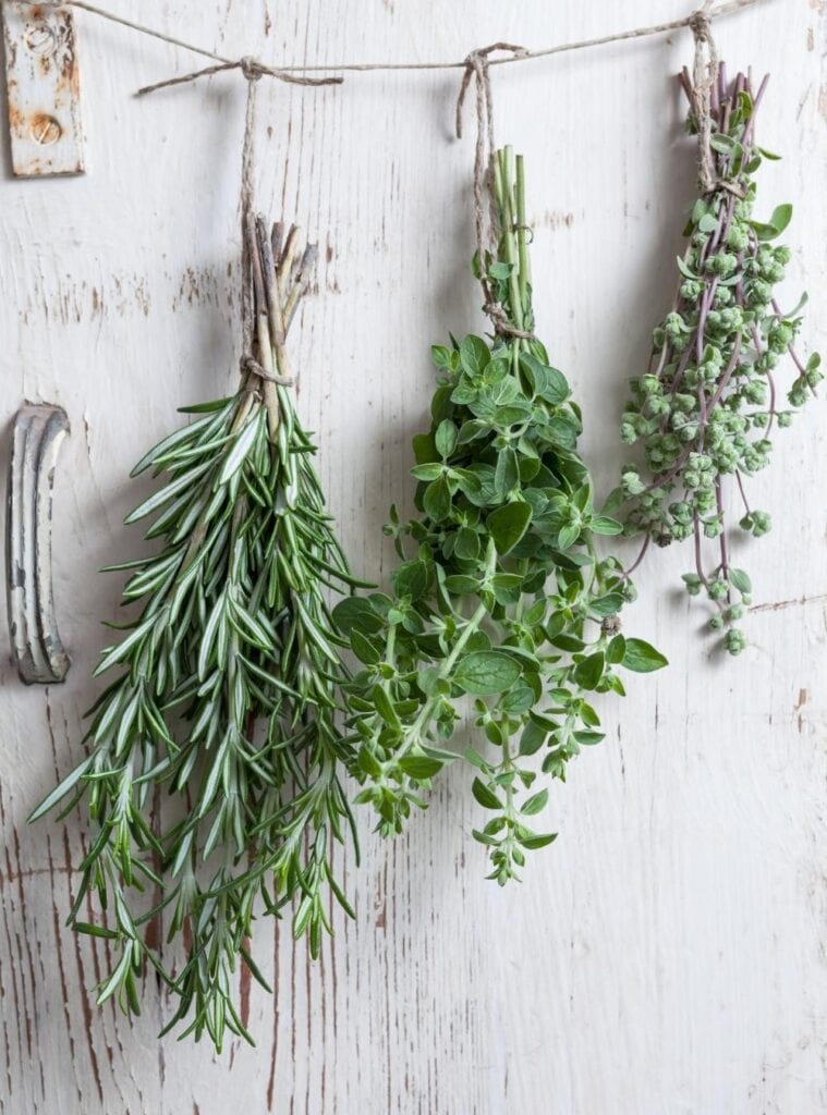 Eucalyptus shower bundle hanging from twine in a steamy bathroom as a natural, wellness-focused Christmas gift.