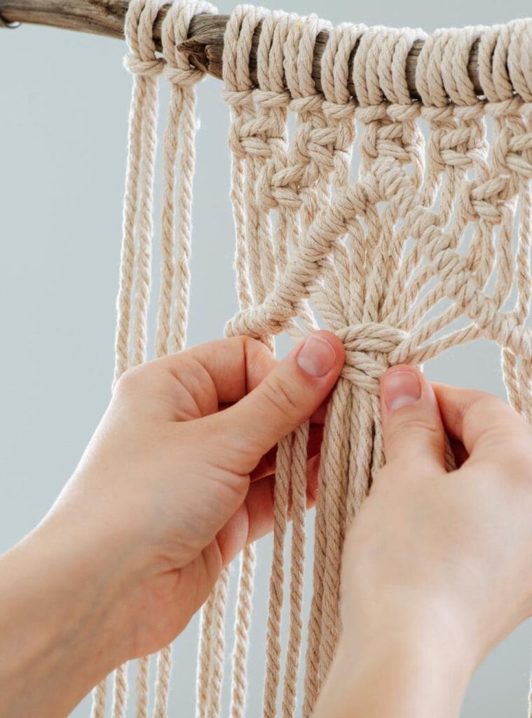 Boho-inspired macrame wall hanging made with natural cotton cord, handmade as a sustainable gift.