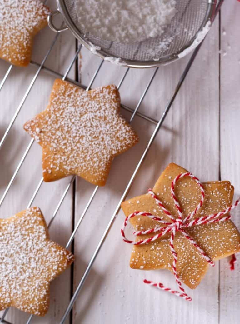 Stack of golden brown shortbread cookies tied with twine, sitting on a linen napkin as a DIY edible gift.