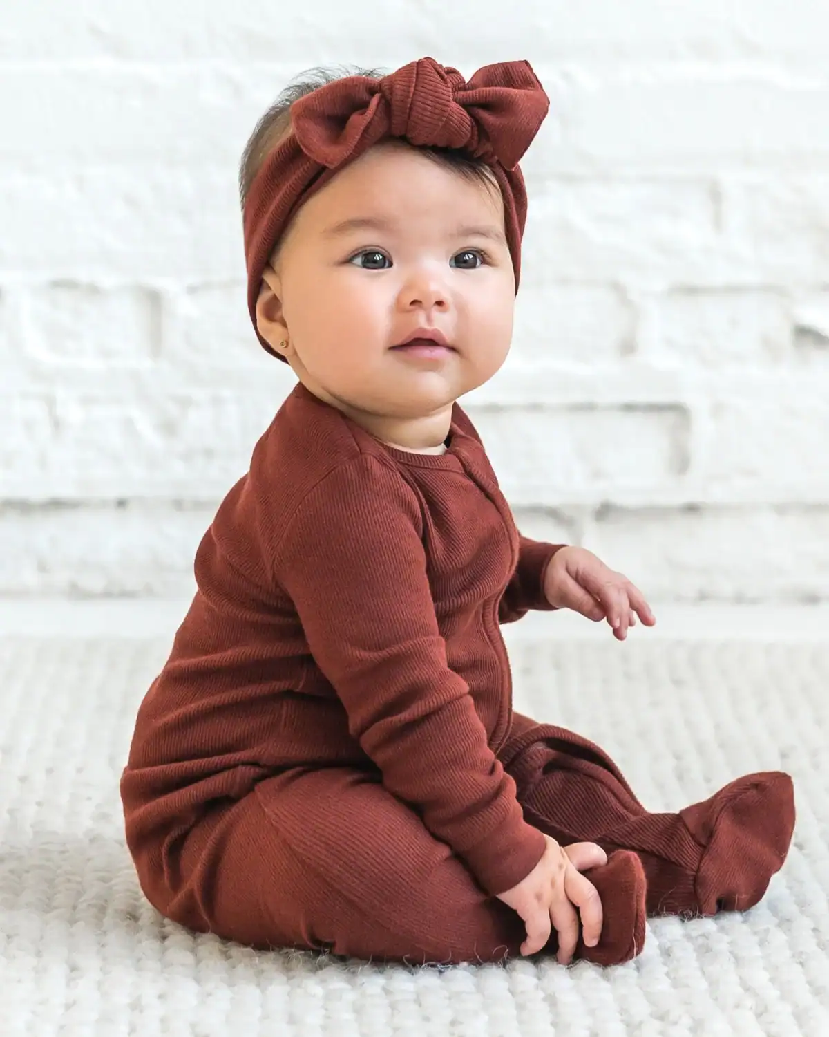Baby wearing Colored Organics GOTS-certified organic cotton baby clothing.