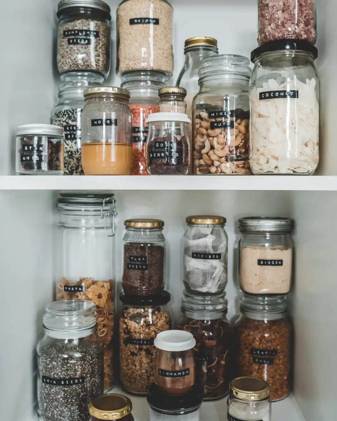 Reused glass jars for non-toxic food storage and pantry organization.