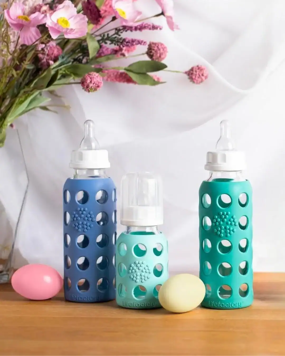 Lifefactory glass baby bottles with protective silicone sleeves for plastic-free feeding.