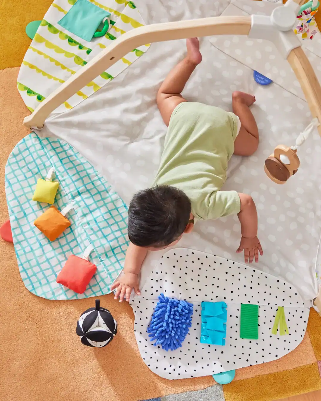 Lovevery play kits with wooden toys and organic materials are designed for baby development.