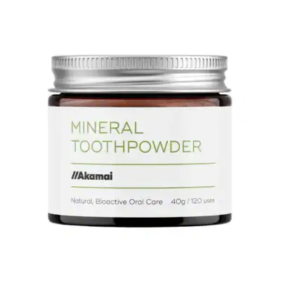 Akamai Mineral Toothpowder in a refillable glass jar designed to support oral microbiome health and tooth remineralization.