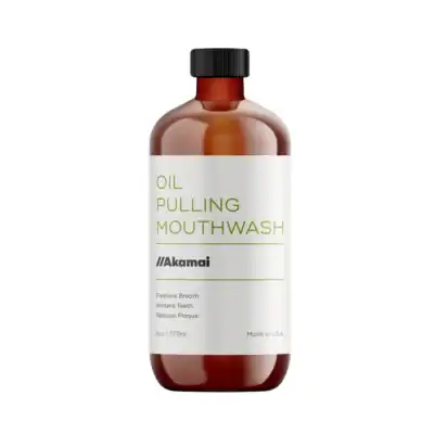 Akamai Oil Pulling Mouthwash in an amber glass bottle made with organic oils to freshen breath and support oral health naturally.