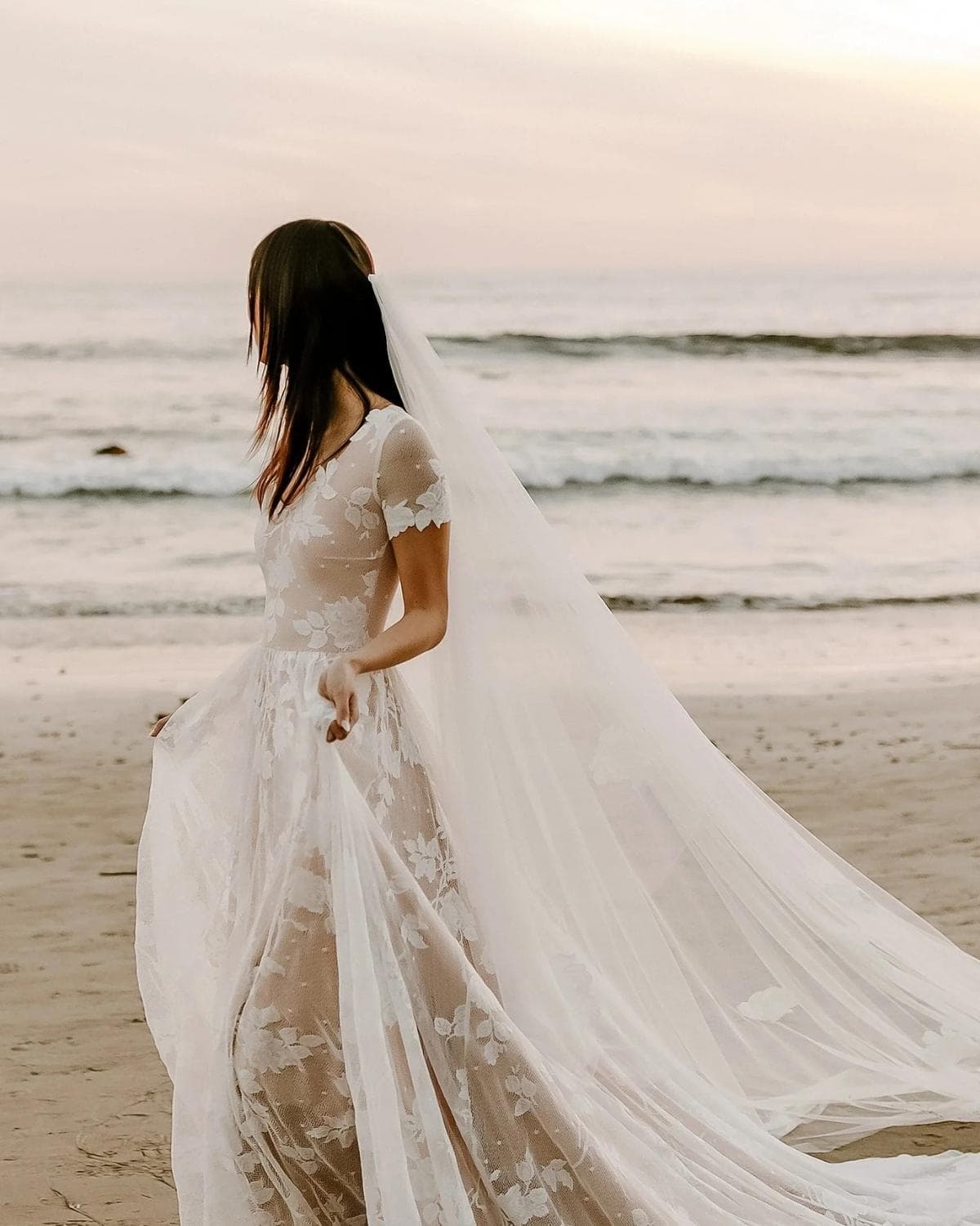 Bride wearing a sustainable wedding dress made from natural fabrics in an outdoor wedding setting.