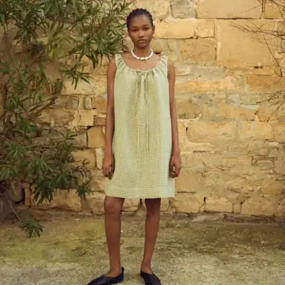 LinenFox Toma gingham linen mini dress in moss green featuring a drawstring neckline, relaxed fit, and lightweight summer linen fabric.