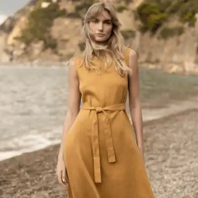 Linen Handmade Studio Chloe sleeveless linen midi dress in warm camel featuring a waist tie, flowing skirt, and timeless summer style.