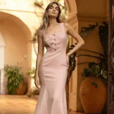 Linen Handmade Studio Valery linen trumpet dress in blush pink featuring a fitted bodice, button-front detail, and elegant flared hem.