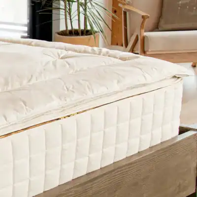 Naturepedic alpaca wool mattress topper featuring ethically sourced alpaca fiber and organic cotton fabric for breathable comfort.