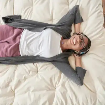 Naturepedic Wooly organic wool mattress topper made with organic wool and organic cotton for temperature regulation and plush comfort.