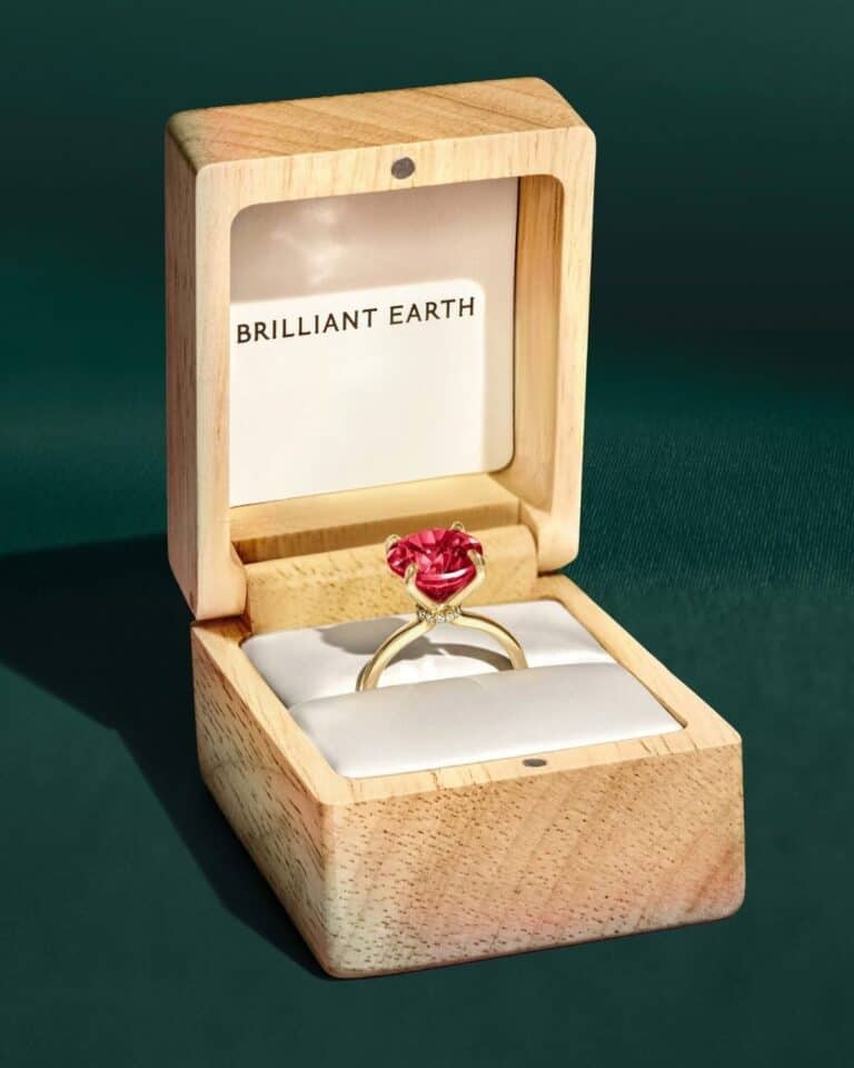 Brilliant Earth pink gemstone engagement ring in a wooden box for a Brilliant Earth vs Blue Nile comparison on sourcing and customization.