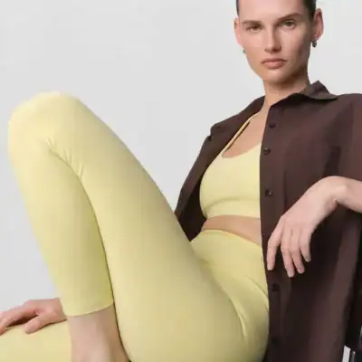 Woman wearing MATE Organic Midi Leggings made with a thick, squat-proof GOTS-certified organic cotton blend.