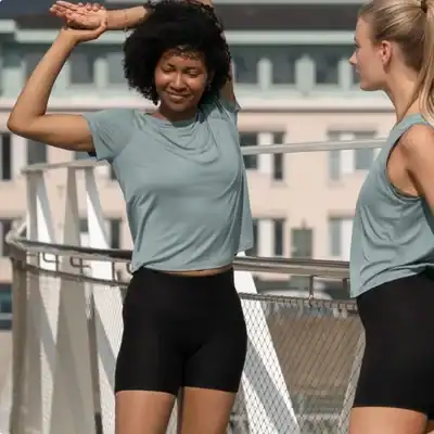 wo women wearing Tripulse Relaxed TENCEL Tank Tops, breathable wood-based activewear for warmer workouts.