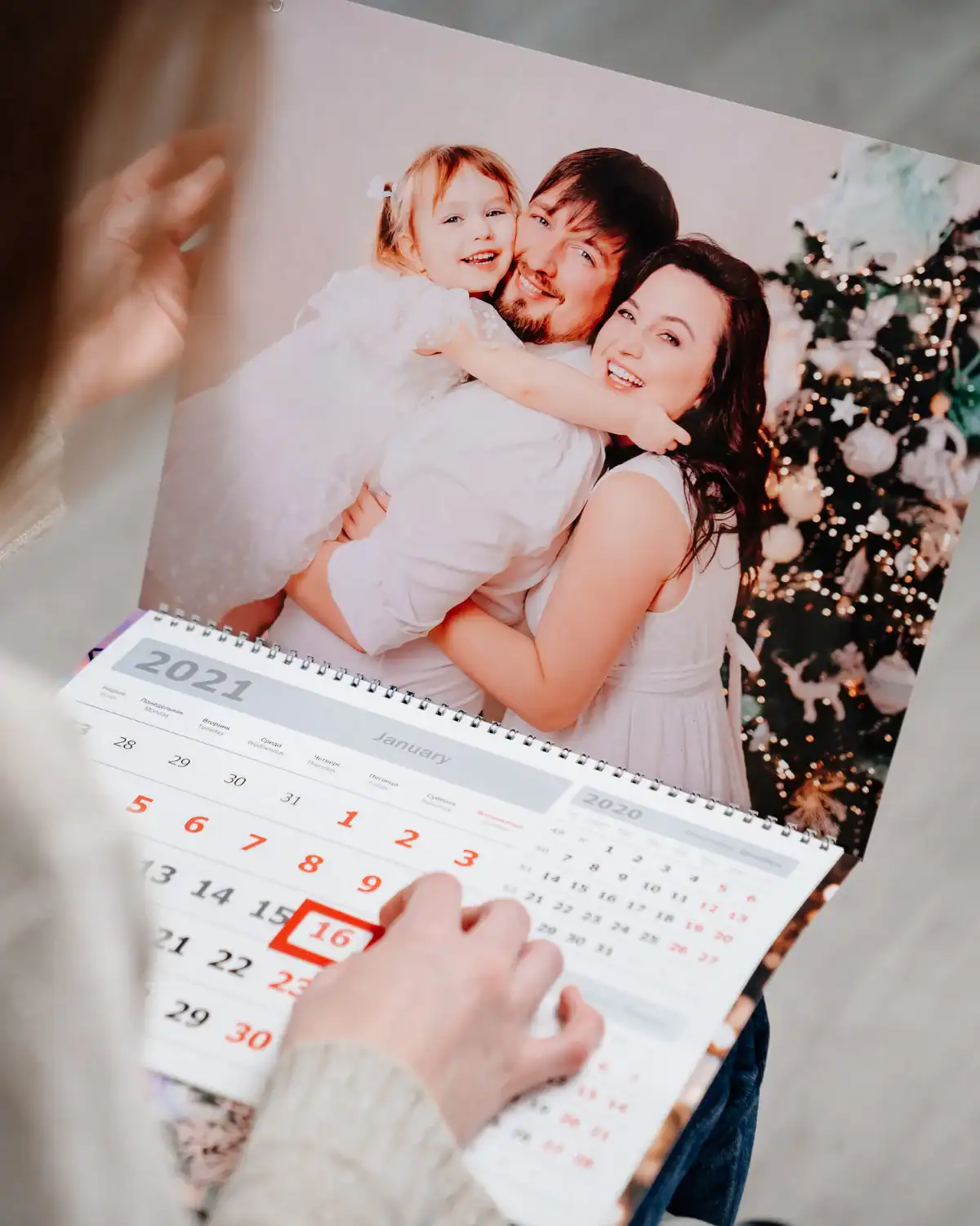 Custom photo calendar printed with family photos for each month.