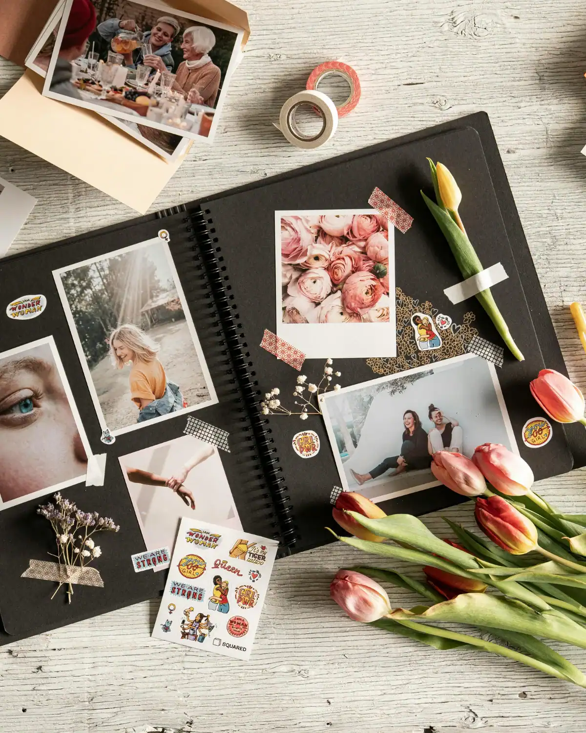 Handmade scrapbook page with photos, pressed flowers, and handwritten captions.