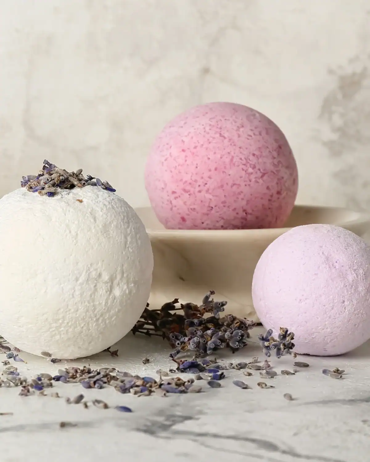 Round homemade bath bombs in a silicone mold before drying.
