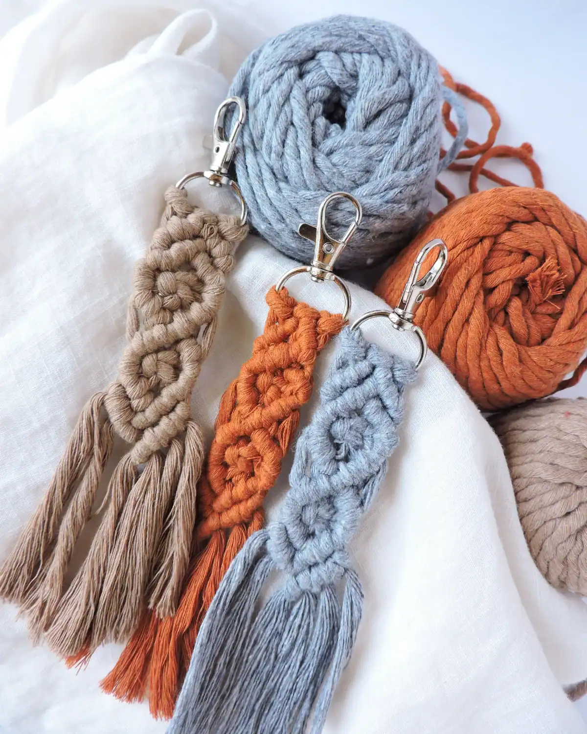 Handmade macrame keychain with a personalized charm.