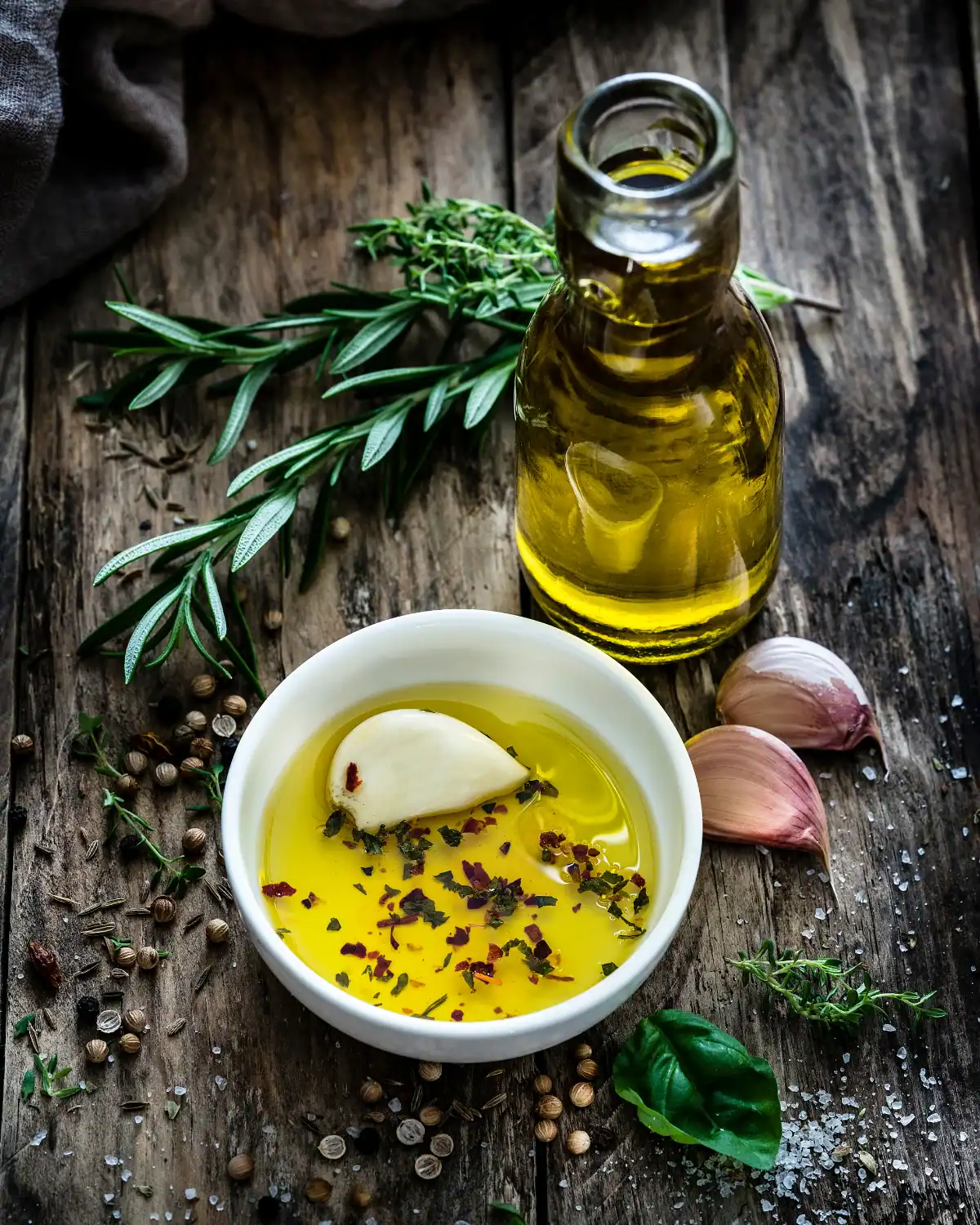 Bottle of garlic-infused olive oil with fresh garlic cloves.