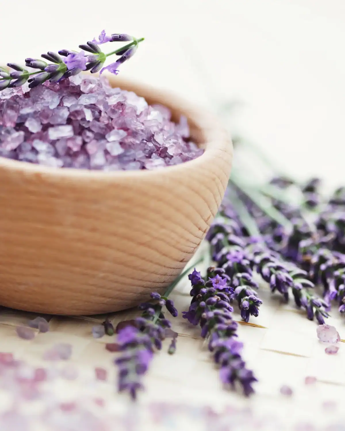 Homemade bath salts in a glass jar with dried lavender and a handwritten gift tag.
