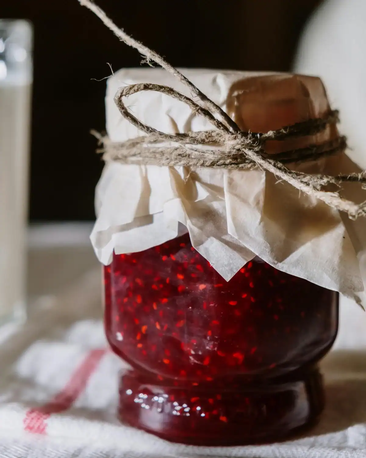 Jar of homemade fruit jam with a handwritten label.
