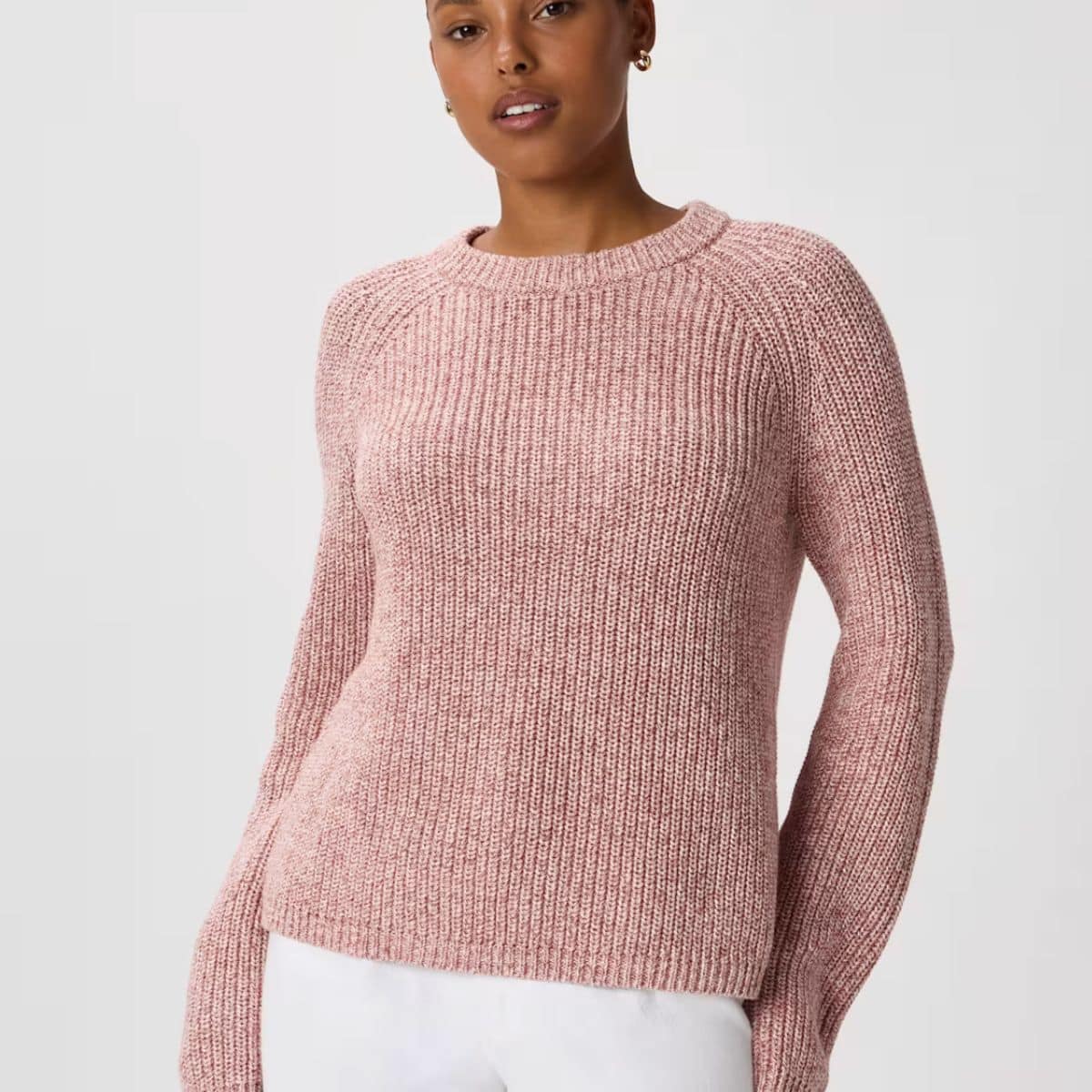 Woman wearing a pink Quince organic cotton crewneck knit sweater with ribbed neckline, cuffs, and hem