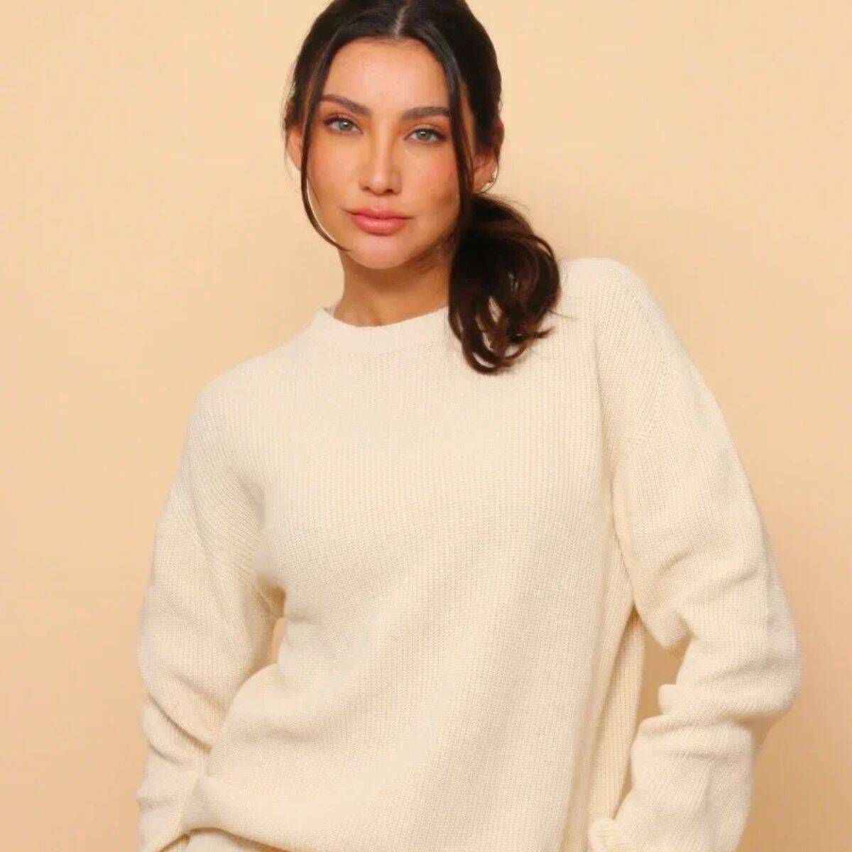 Woman wearing a cream Cottonique hypoallergenic organic cotton knit sweater featured in my guide to the 10 best non-toxic sweaters and cardigans.