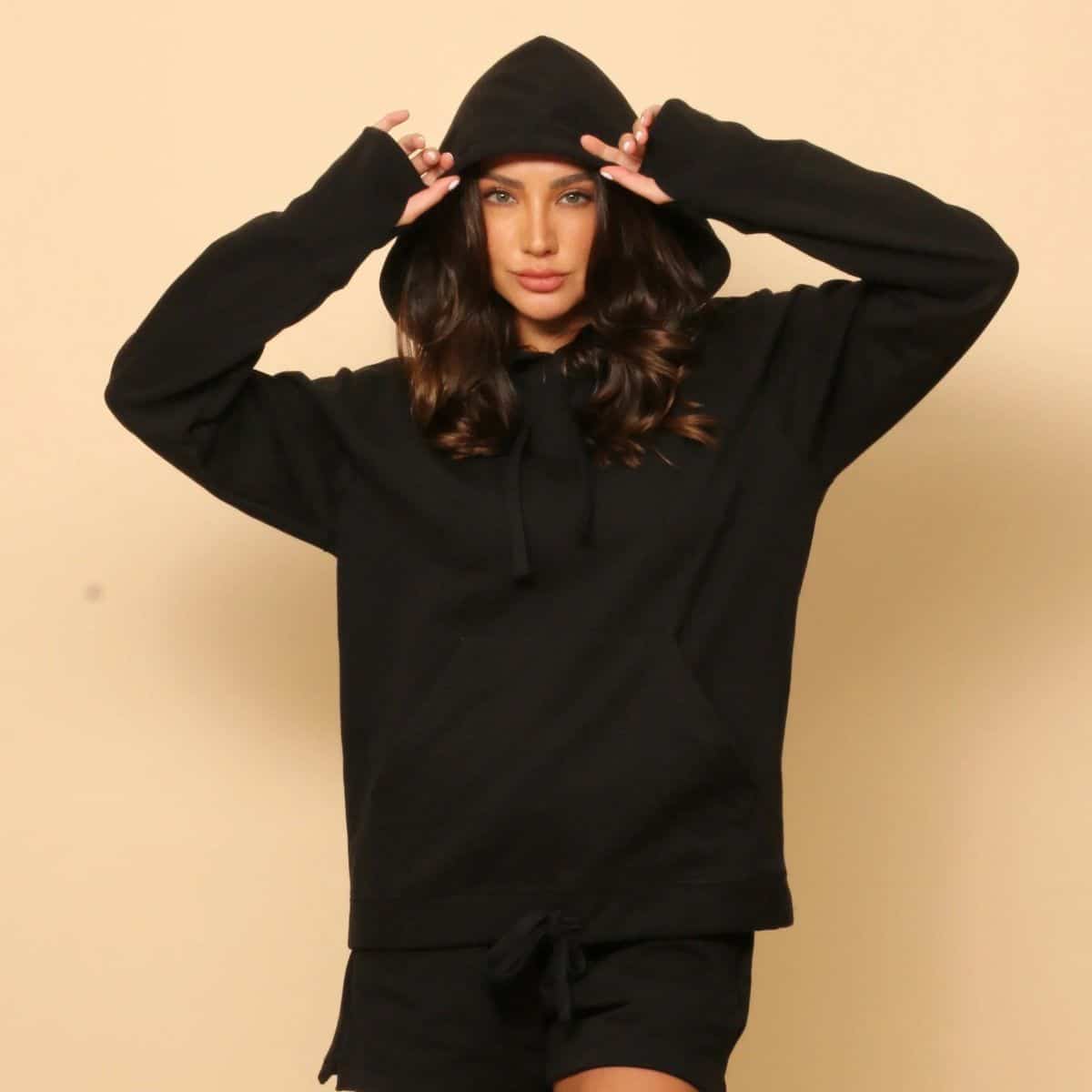 Woman wearing a black Cottonique hypoallergenic organic cotton hoodie featured in my non-toxic sweaters and natural-fiber knitwear guide.