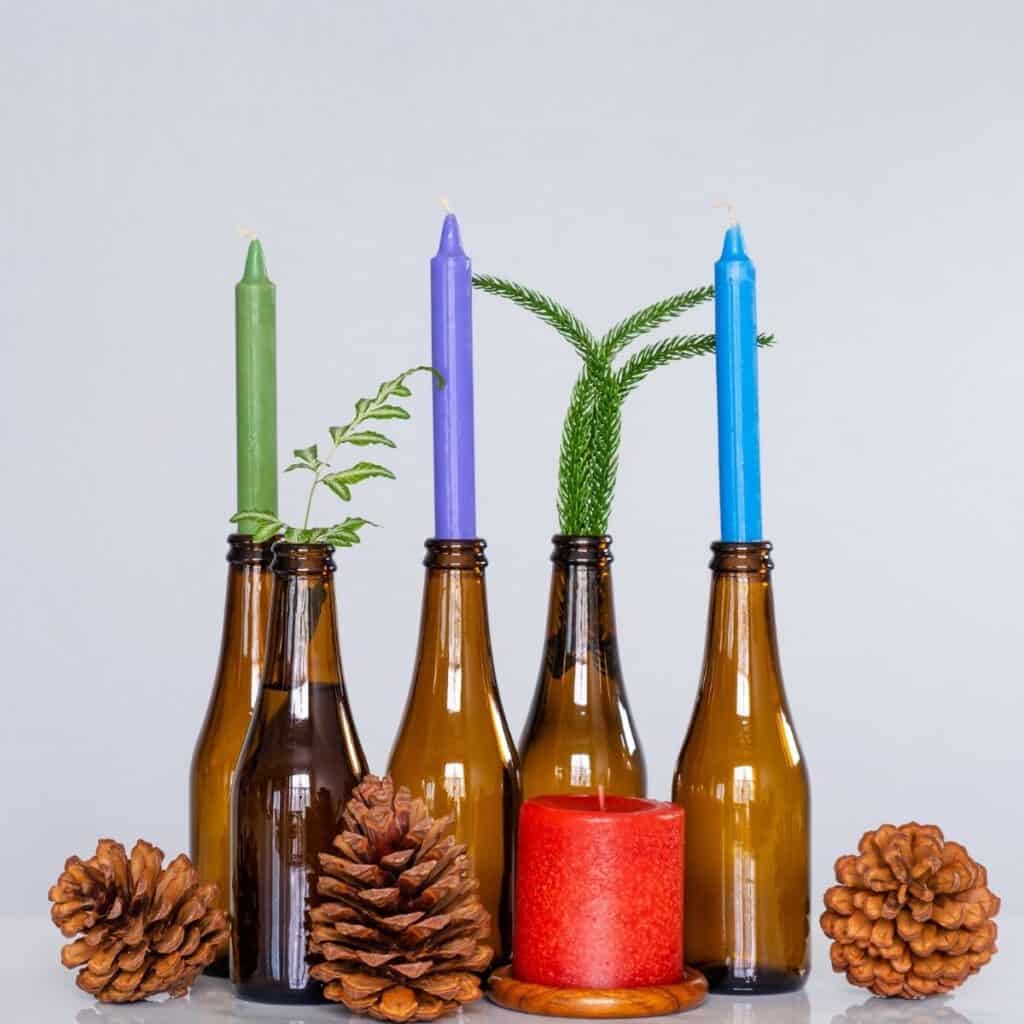 Repurposed glass bottles used as candle holders for simple non-toxic Christmas decor.