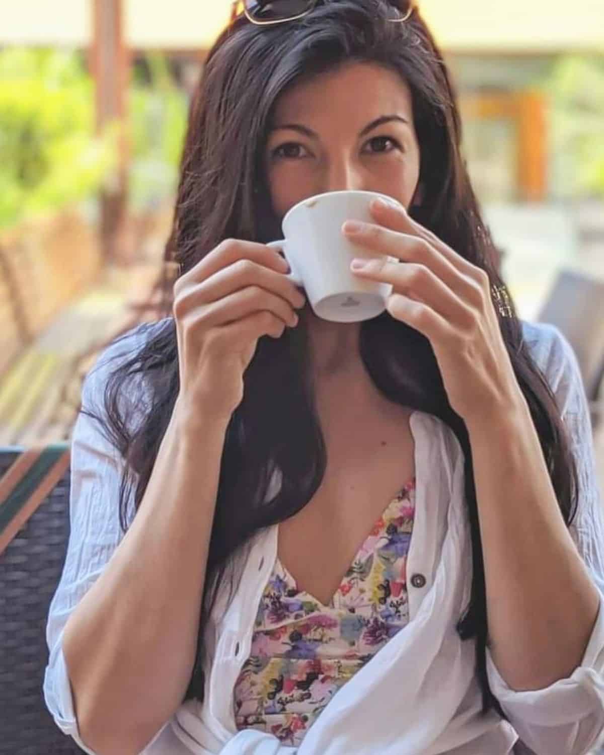 SKL reviewer, Danielle Alvarado, drinking coffee from a white cup, accompanying our firsthand guide to the best non-toxic coffee brands
