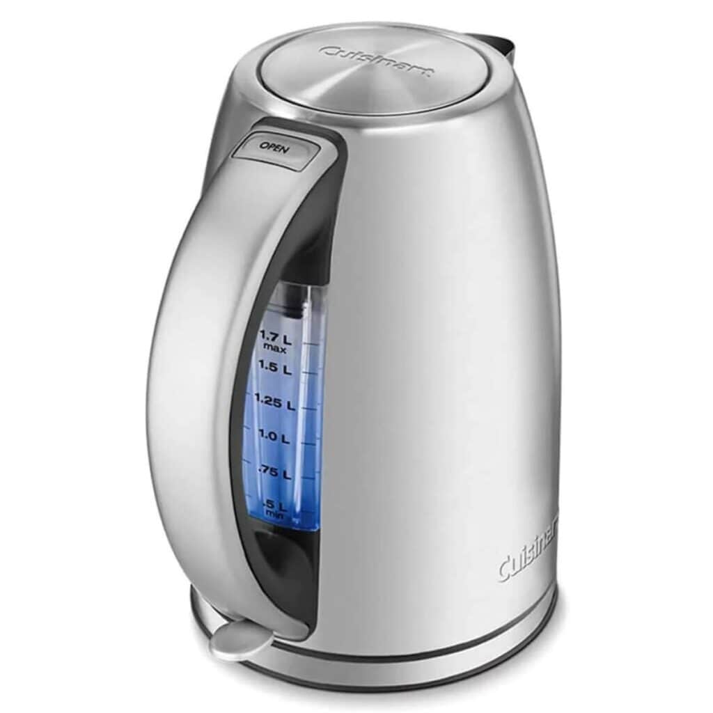 Silver Cuisinart electric tea kettle with a blue water-level window beneath the handle and a lid-release button