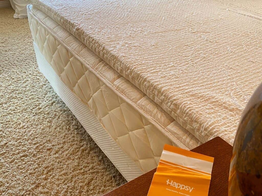 Happsy Plush King mattress with the organic topper added, showing its textured surface and layered profile.