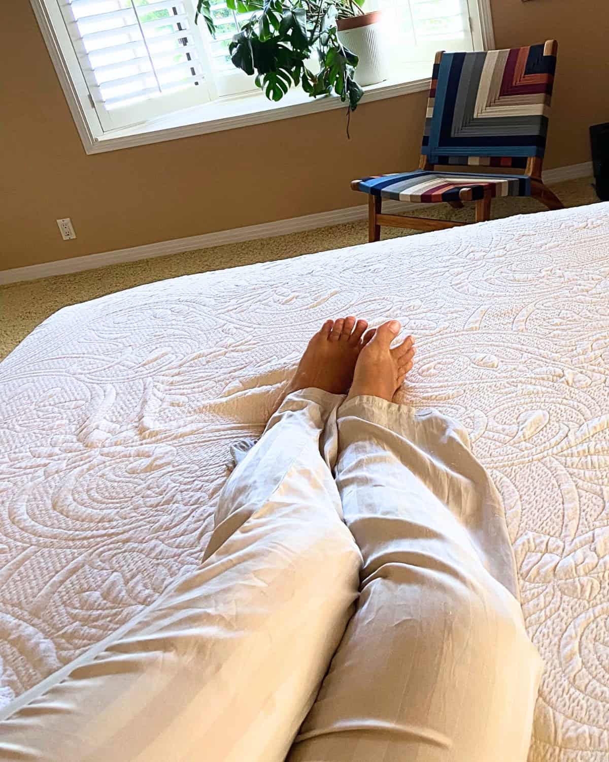 irst-person view of resting on the Happsy Plush King mattress with its organic topper during at-home comfort testing.
